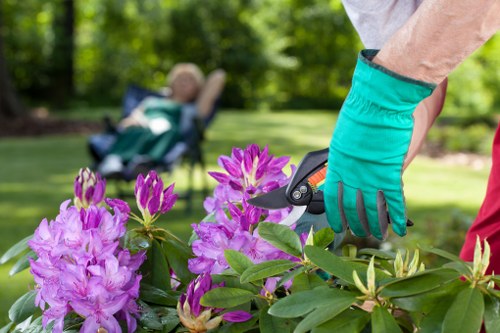 Improving soil and adding mulch during flower bed creation in Alperton