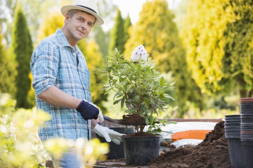 Landscapers preparing a durable and detailed garden installation in Alperton